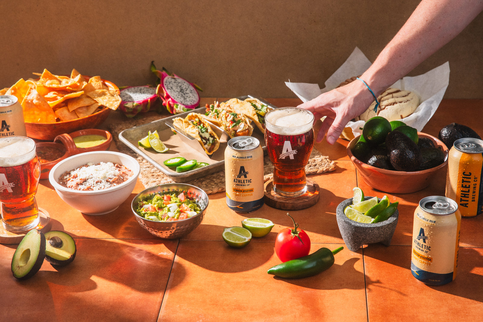 Cerveza surrounded by Mexican style foods