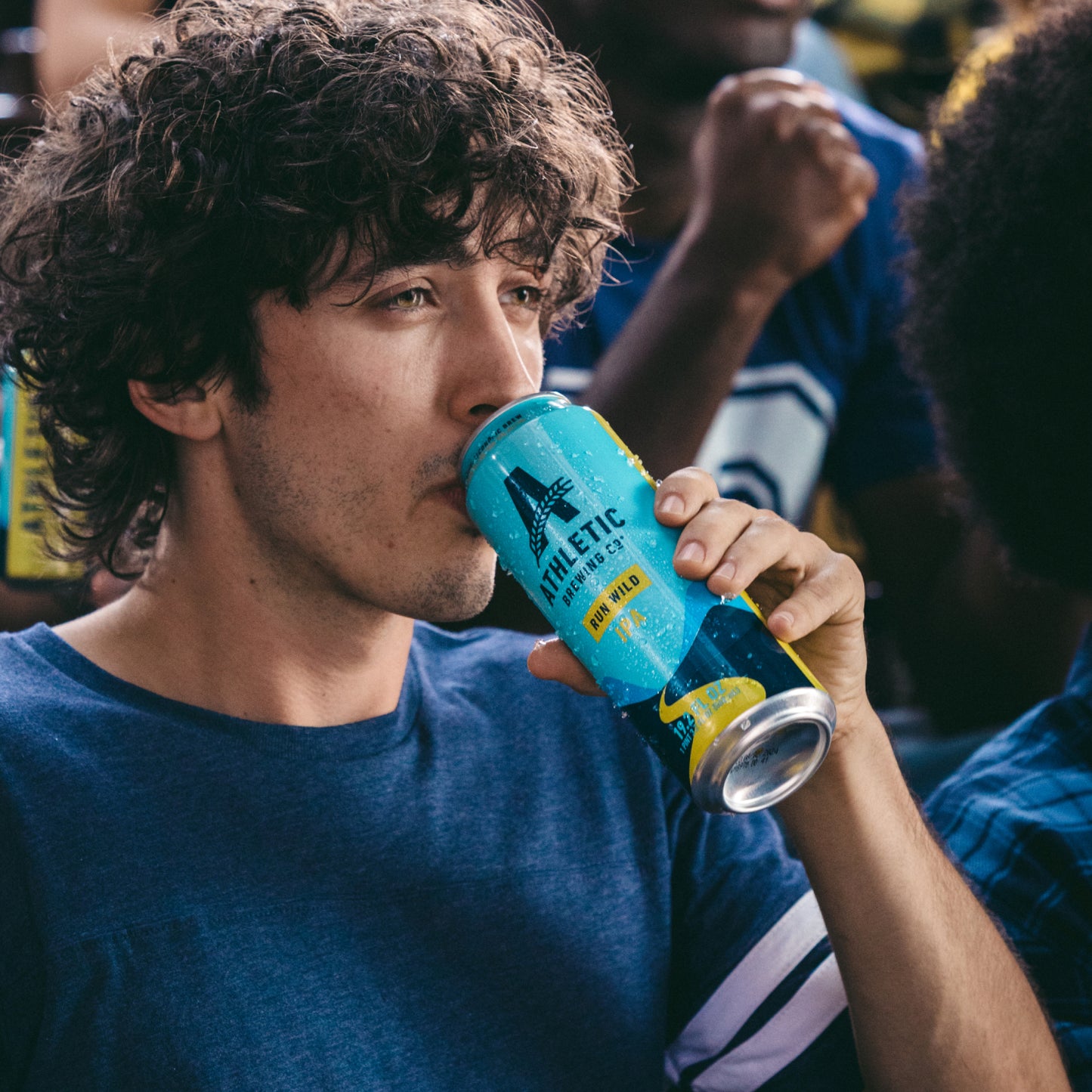 a man drinking a 19.2oz of run wild